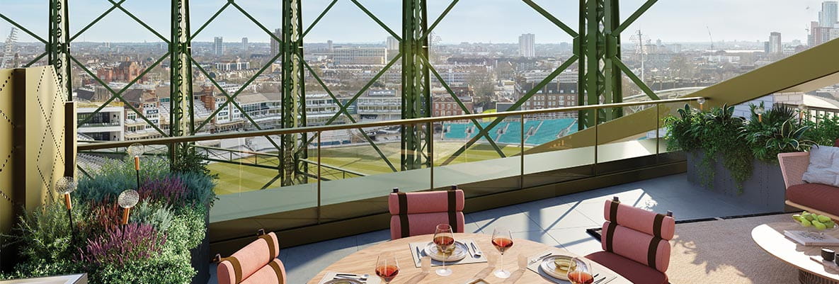 A rooftop terrace with modern seating and a round dining table set for meals, overlooking a scenic cityscape through metal framework.