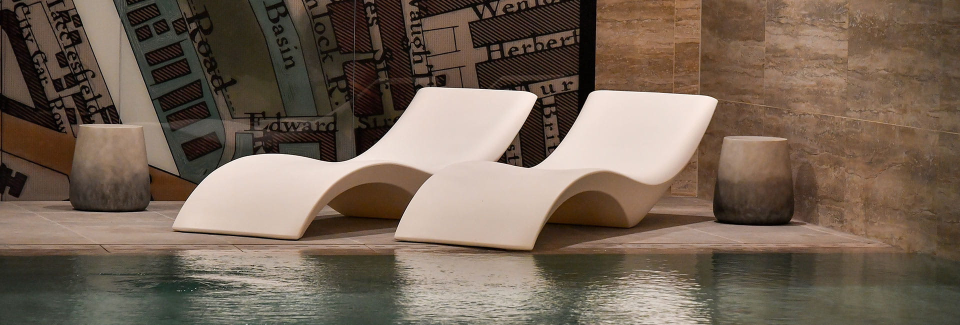 Two loungers located next to the residents-only swimming pool at 250 City Road development by Berkeley Group. 