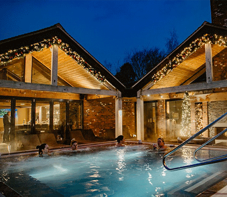 Guests enjoy the outdoor swimming pool of the Moddershall Oaks luxury spa hotel in Staffordshire.
