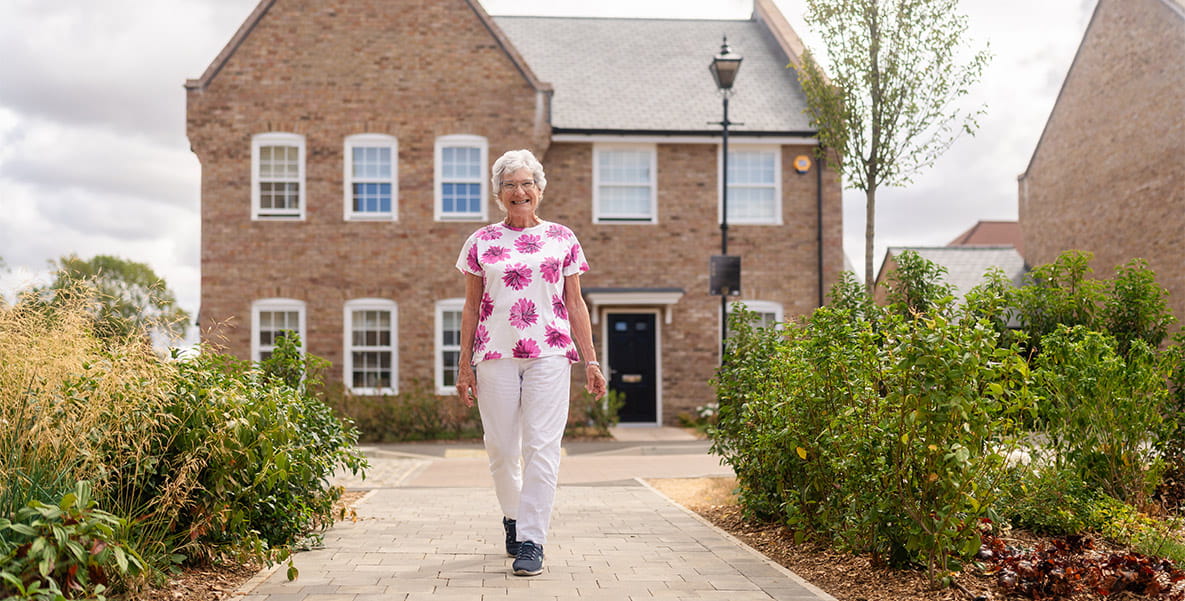 Elizabeth in front of new build home.