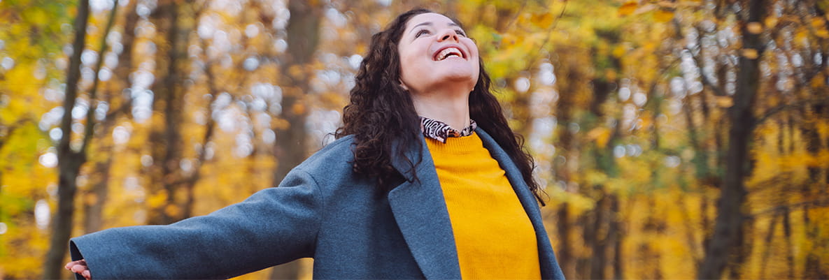 An image of a woman de-stressing within a forest