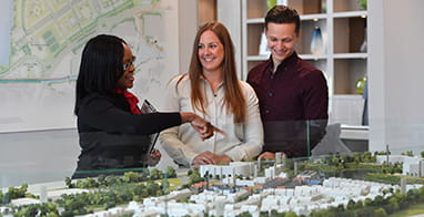 An image of a couple being shown the development build in a Sales and Marketing Suite