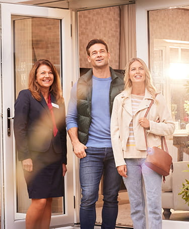 An image of potential customers meeting with a Sales Executive