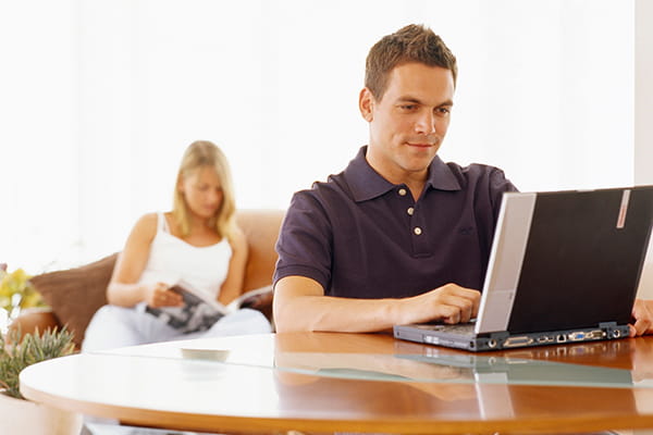 An image of a man using his computer