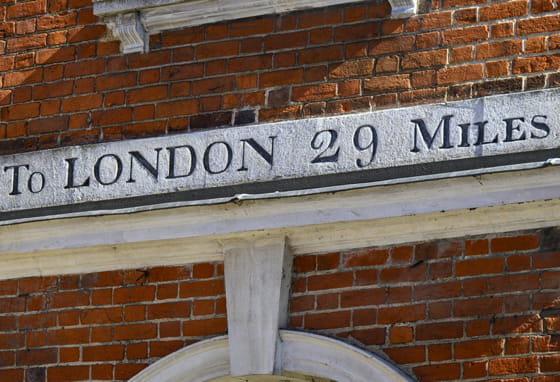Sign on a building in High Wycombe saying To London 29 miles