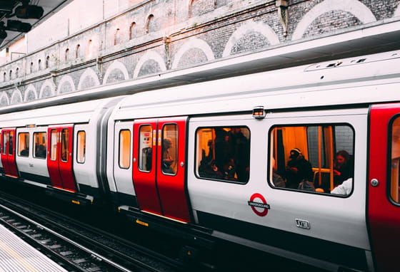 A London Overground train arriving at a station platform