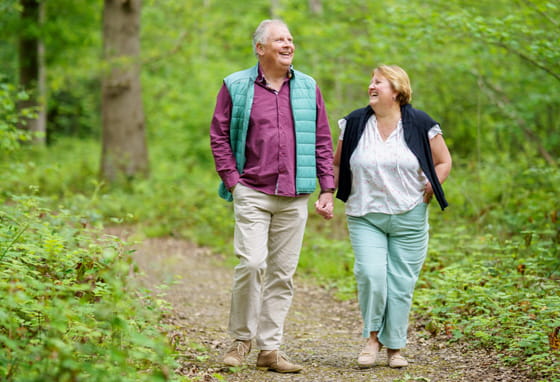 Couple walking in woods at Foal Hurst Green in Paddock Wood