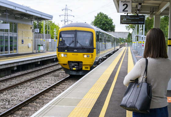 A woman standing at a train station