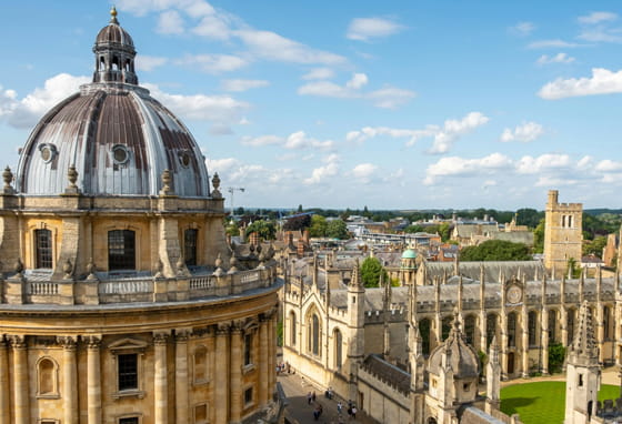 Bodleian Library and Radcliffe Camera connected by a stone walkway in Oxford