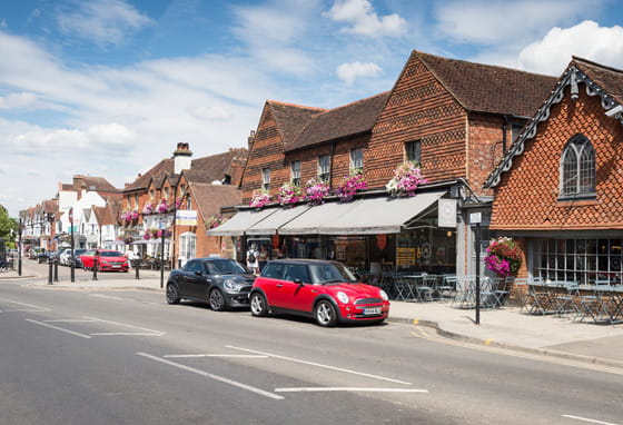 Cranleigh village centre in Surrey with traditional shops and surrounding countryside 