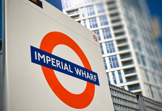 Imperial Wharf Overground station sign with buildings in the background.
