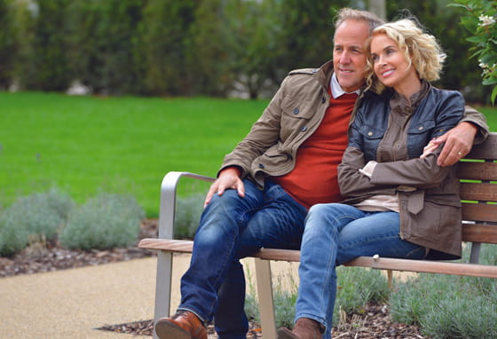Couple sitting on a bench in Highcroft Village, West Sussex	