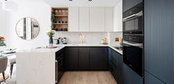 Kitchen area with a dark blue design and white marble worktops