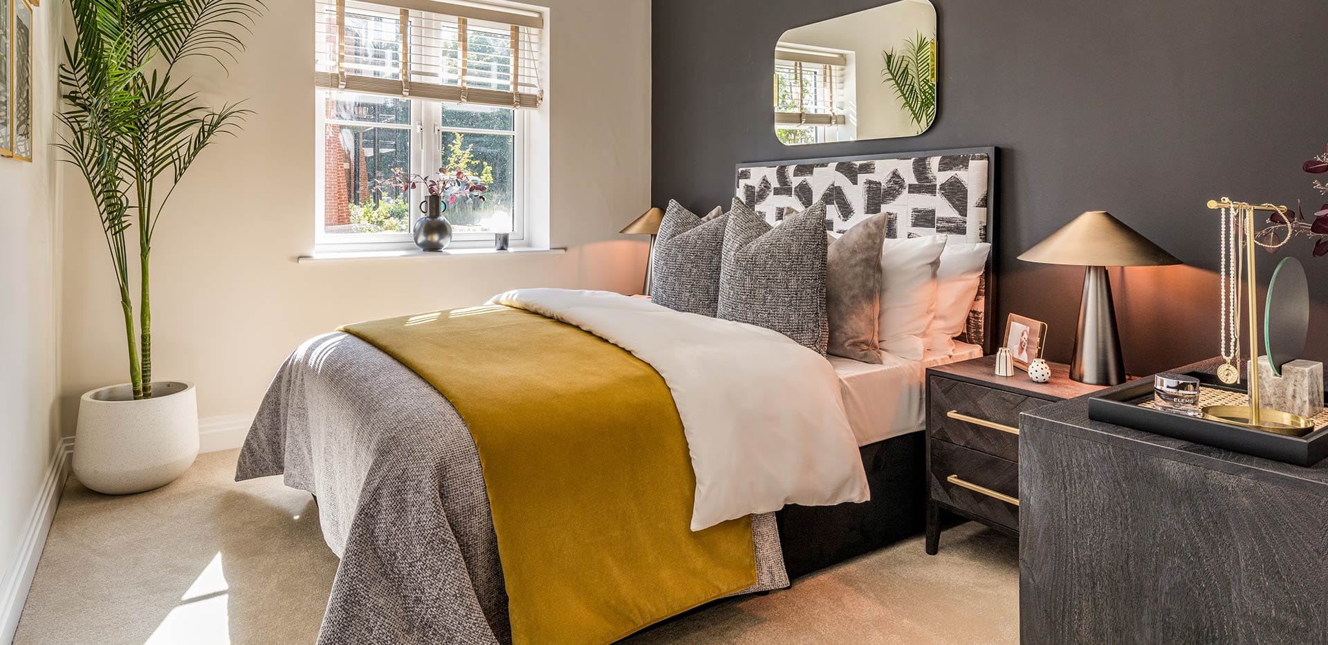 An interior Bedroom image with a grey feature wall at Dorsett House at Abbey Barn Park