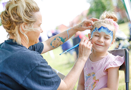An image of a young girl getting her face painted