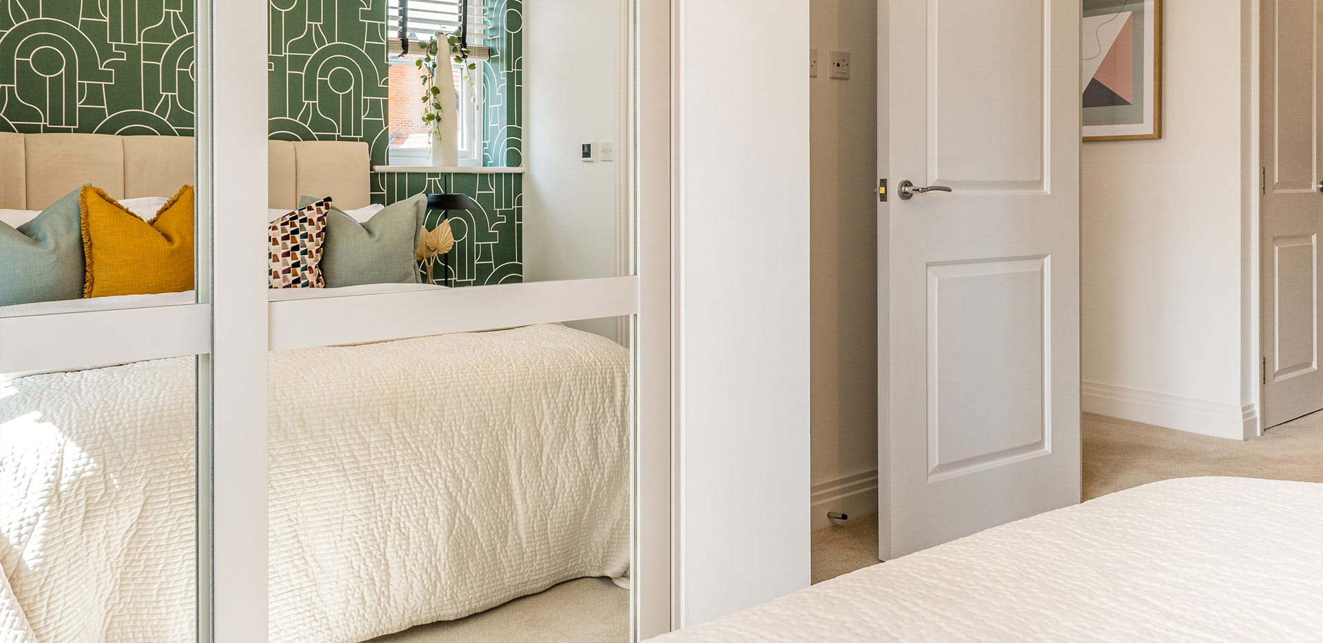 An interior Bedroom image witha reflection of the Bed in the wardrobe mirrors