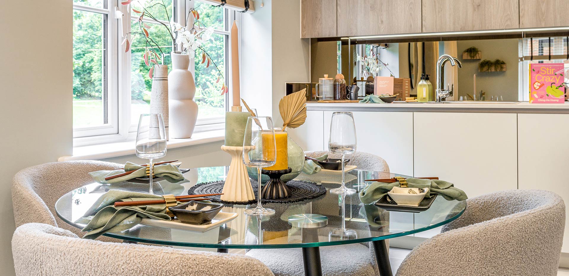 An interior image of the Dining / Kitchen area with a glass table