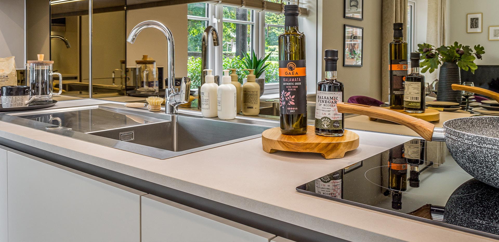 An interior Kitchen close up image showing the sink and induction hob