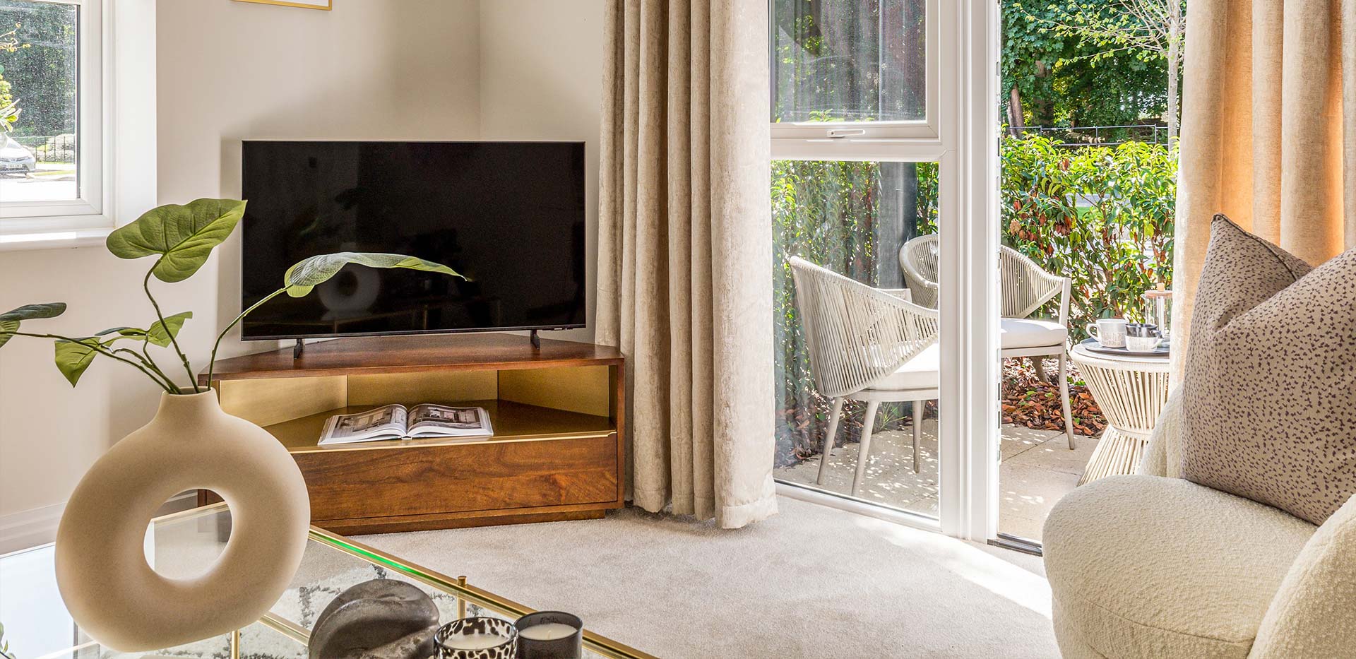 An interior Living Room image with a TV and doors to the outside