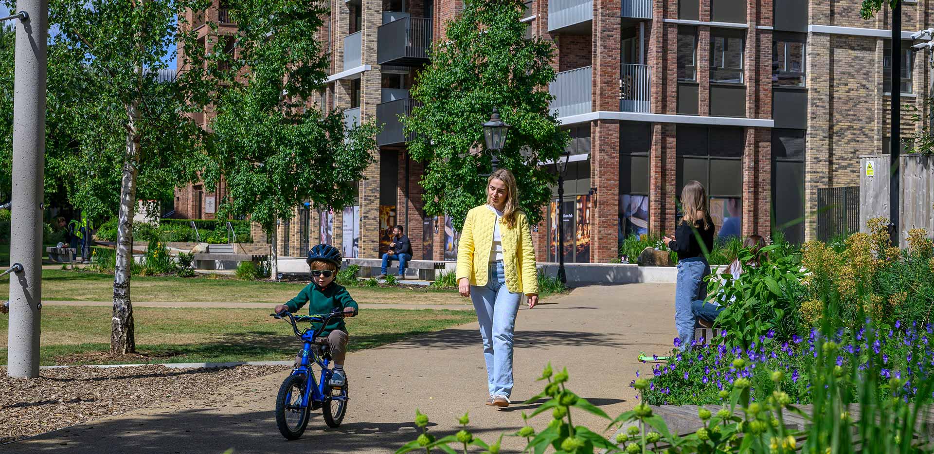 An exterior image of residents using the outer grounds of Alexandra Gate