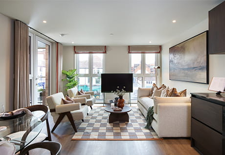 Modern designed living space with seating, coffee table, rug, TV.