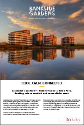Modern new build development with building reflection in a body of water in the foreground