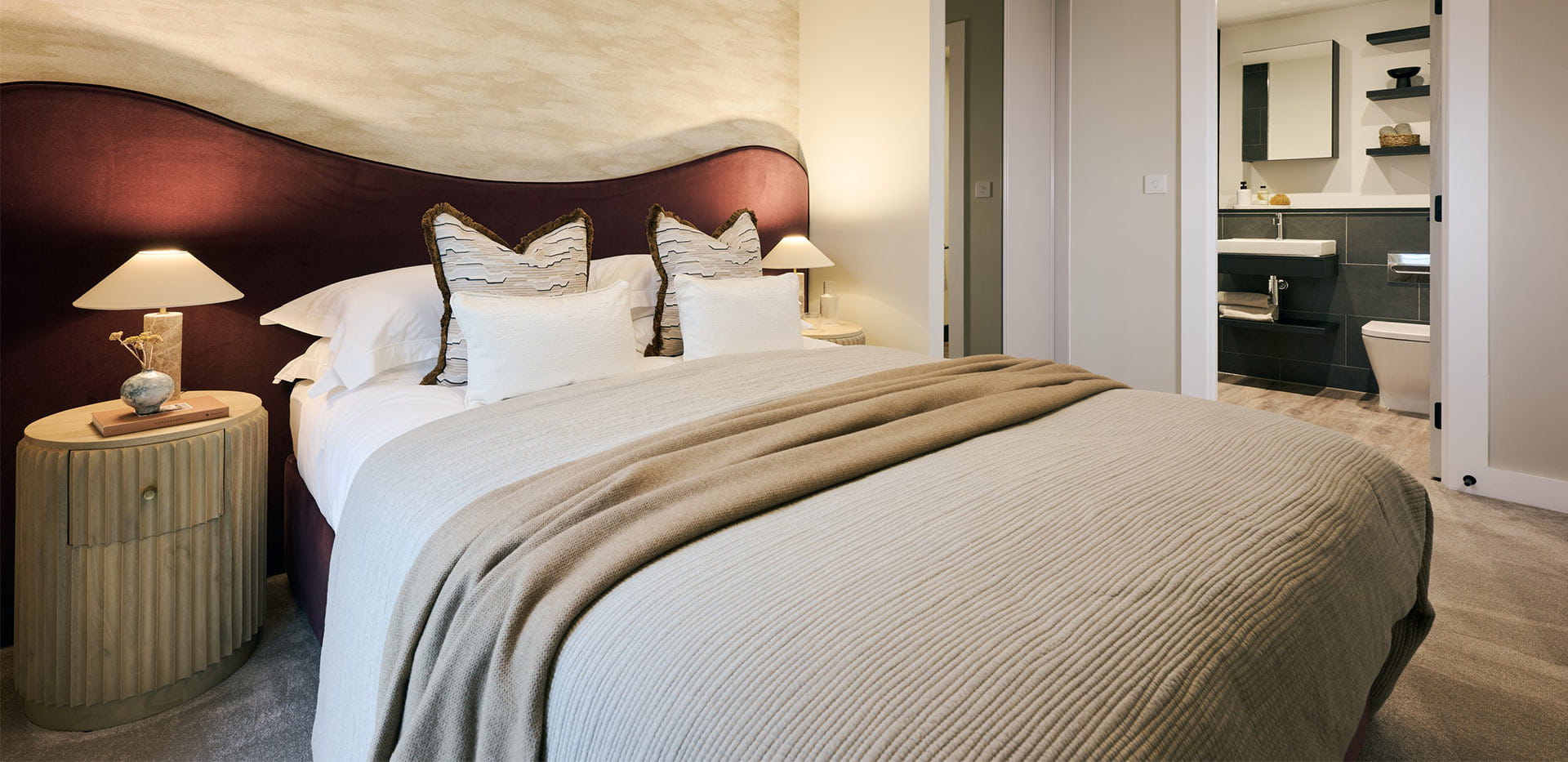 An interior Bedroom with red headboard shot at Bankside Showhome 7.4.6