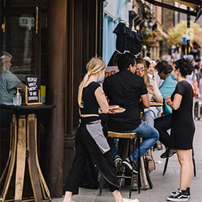People dining alfresco outside a bar