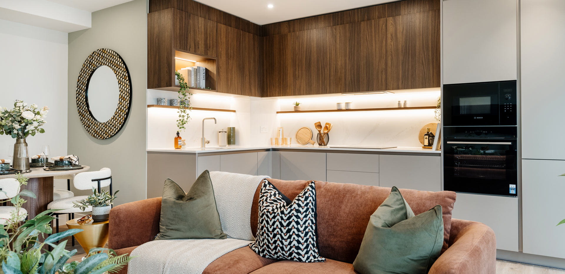 Living space in foreground, kitchen with dining table in background.