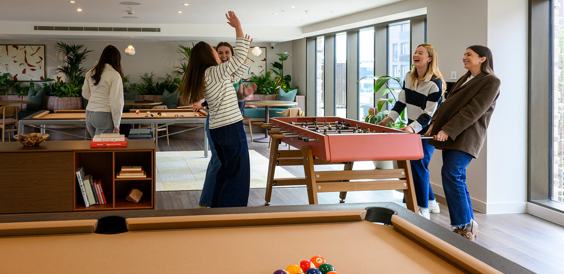 An image of people playing table football at Bow Green
