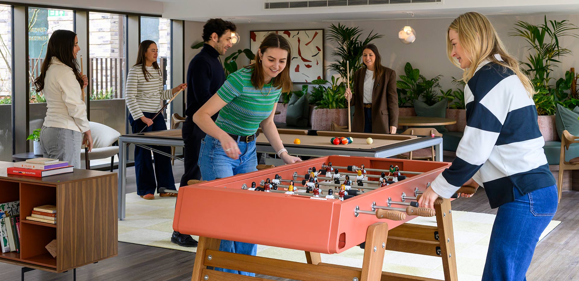 An image of people playing games in the Games Room at Bow Green