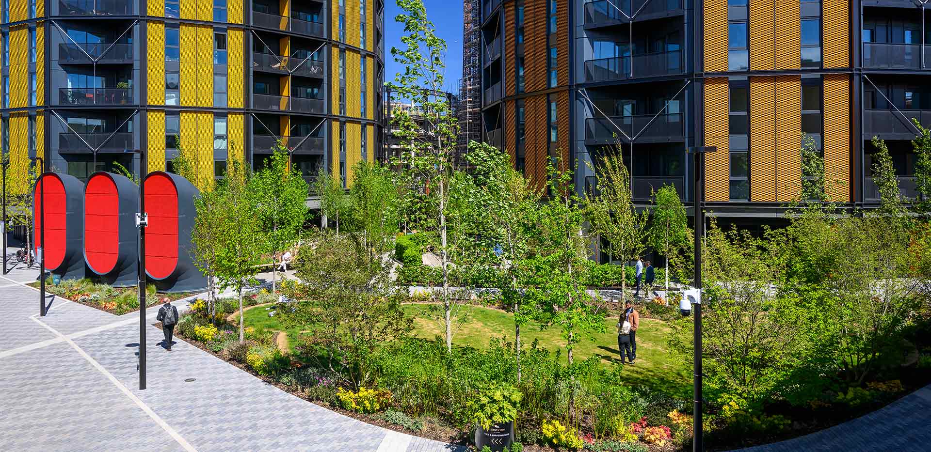 External facade of new build development and landscaped greenspace in front.