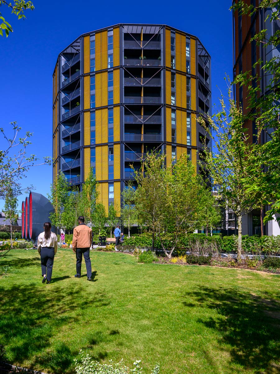 External facade of new build development and landscaped greenspace in front.