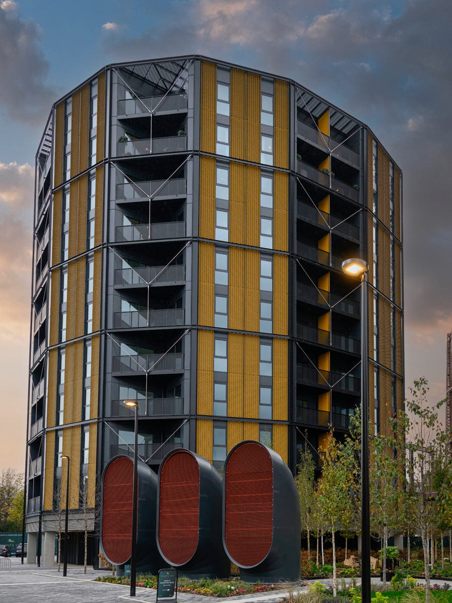 External façade of new build development and landscaped greenspace in front.