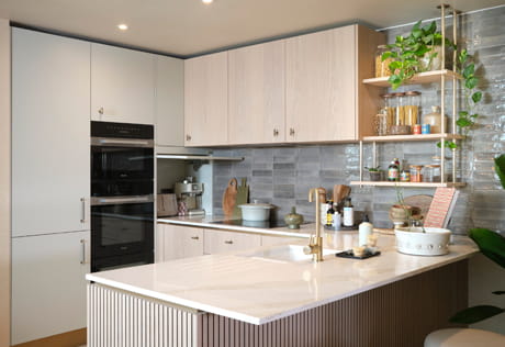 Kitchenette with breakfast island wraparound counters, cabinets and counters in beige grey