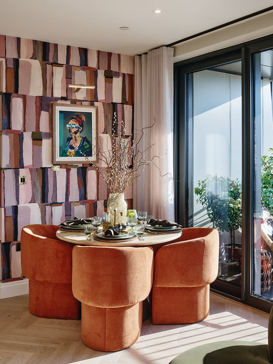 Circular dining table sat beside full length window