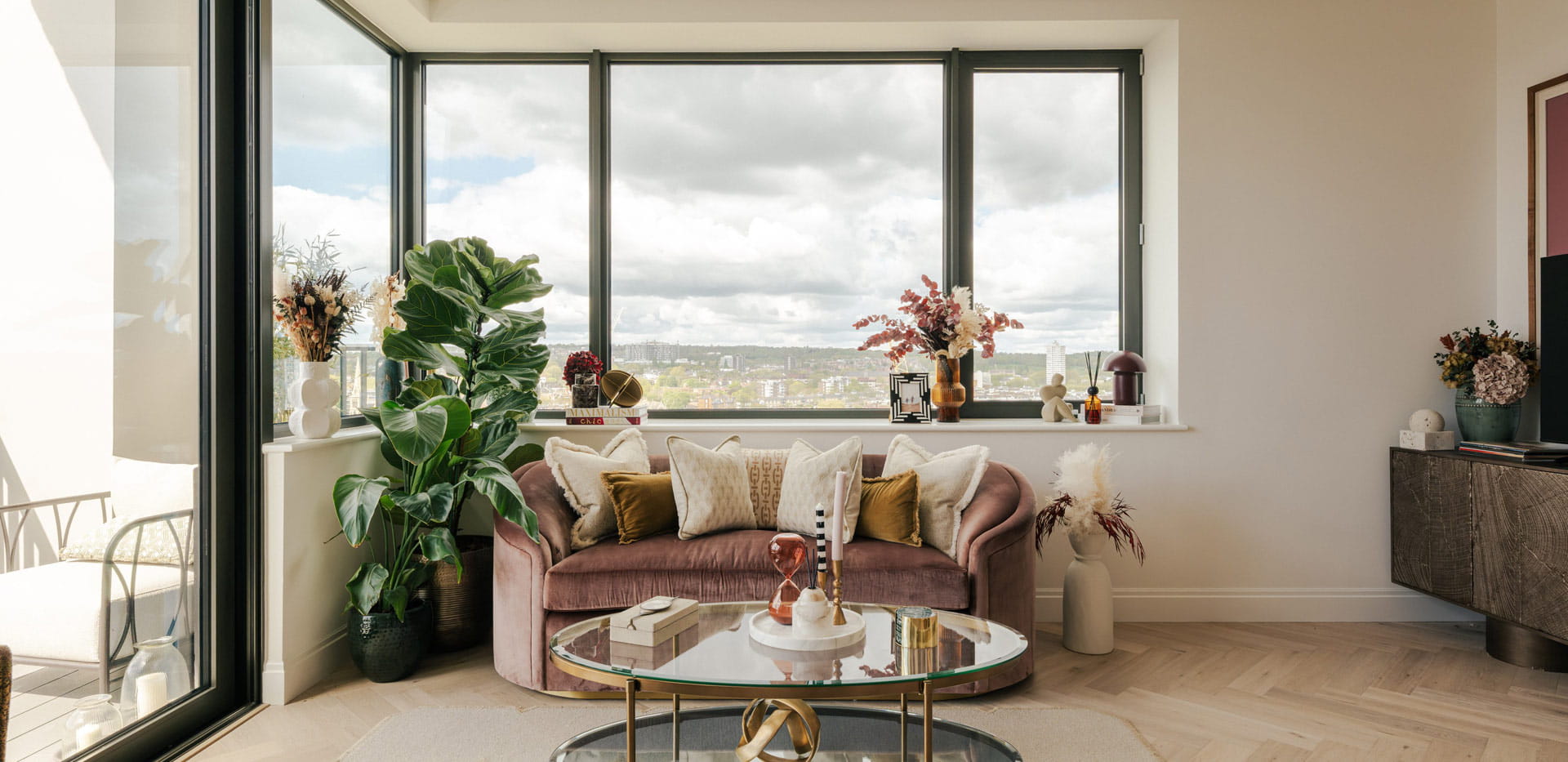 Modern designed living space with sofa and coffee table adjacent to balcony doors.