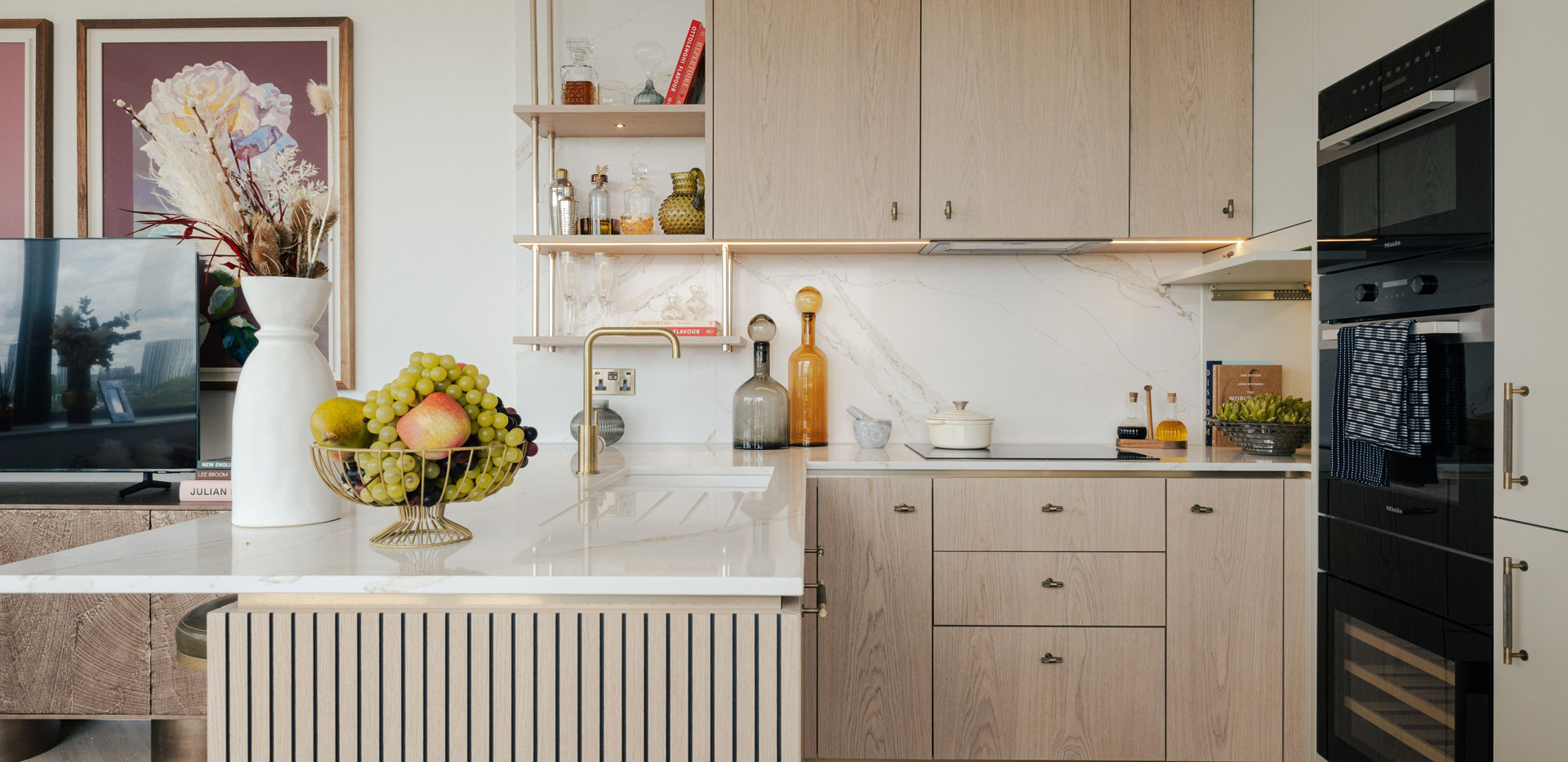 Closeup of kitchenette and island, light brown beige colour palette.