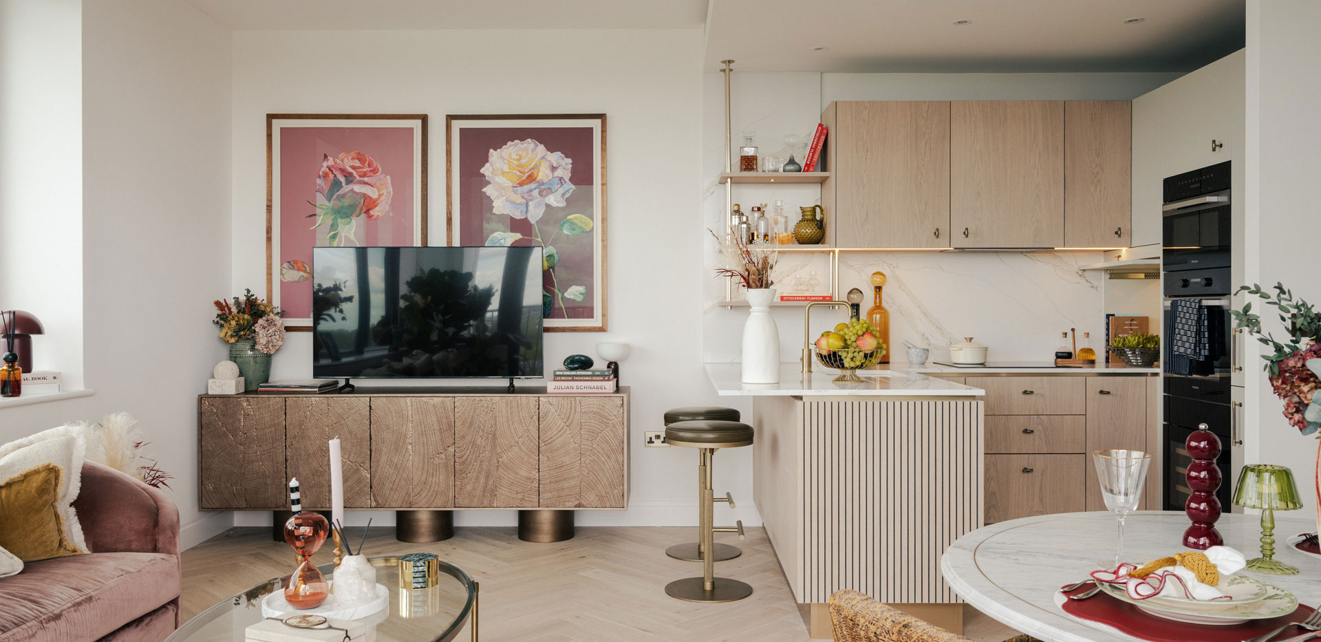 Kitchenette with attached island, dining table and living space combined.
