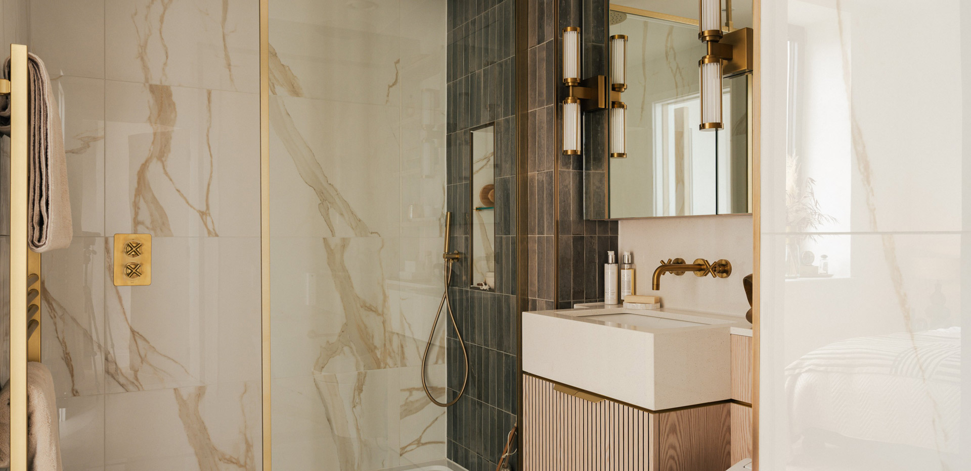 Modern designed bathroom with shower unit, marble-gold streak texture and sea-green tiles.