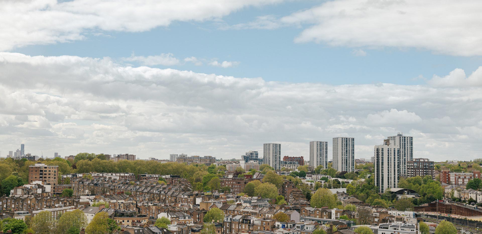 Aerial view of city town interspersed with trees.