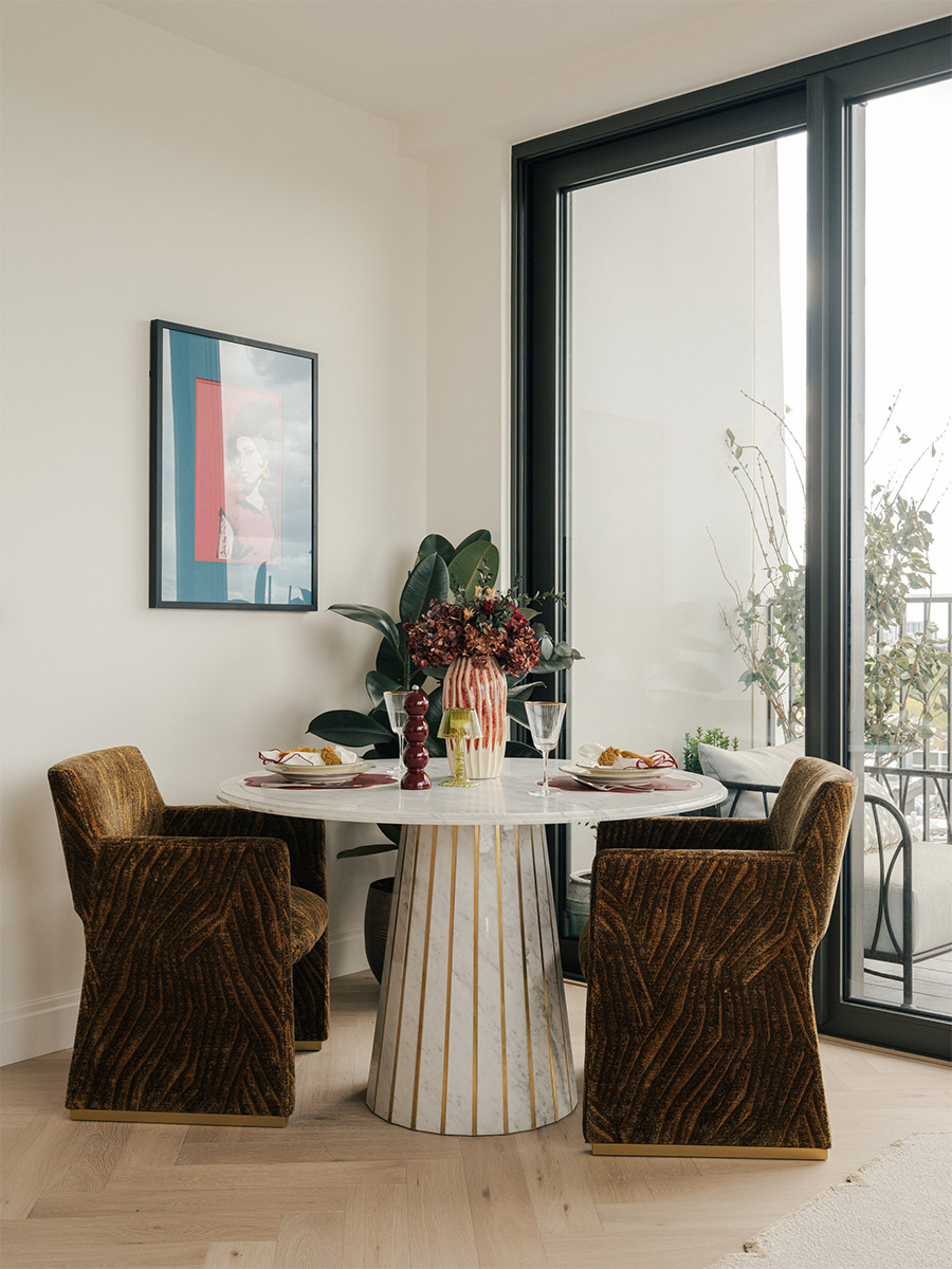 Closeup of dining table against wall and adjacent to balcony doors.