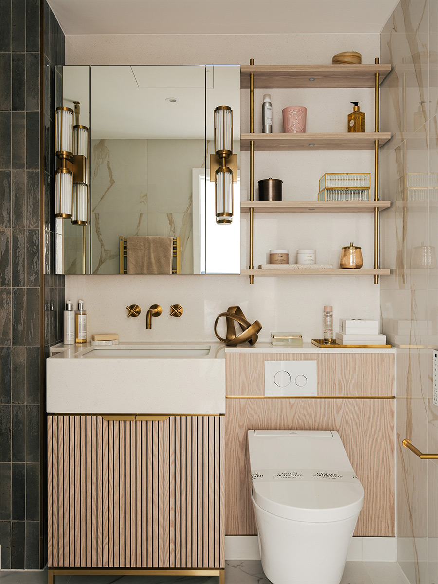 Modern designed bathroom, wash basin with wall mirror, toilet and multi-level shelving unit.