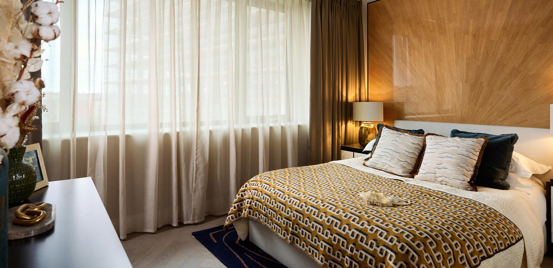 An image of a bedroom within The Signature Collection showhome, with a gold interior palette