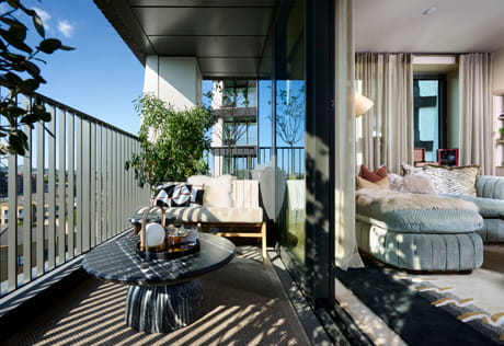 View of balcony outdoor furniture, sliding doors, adjacent to living space