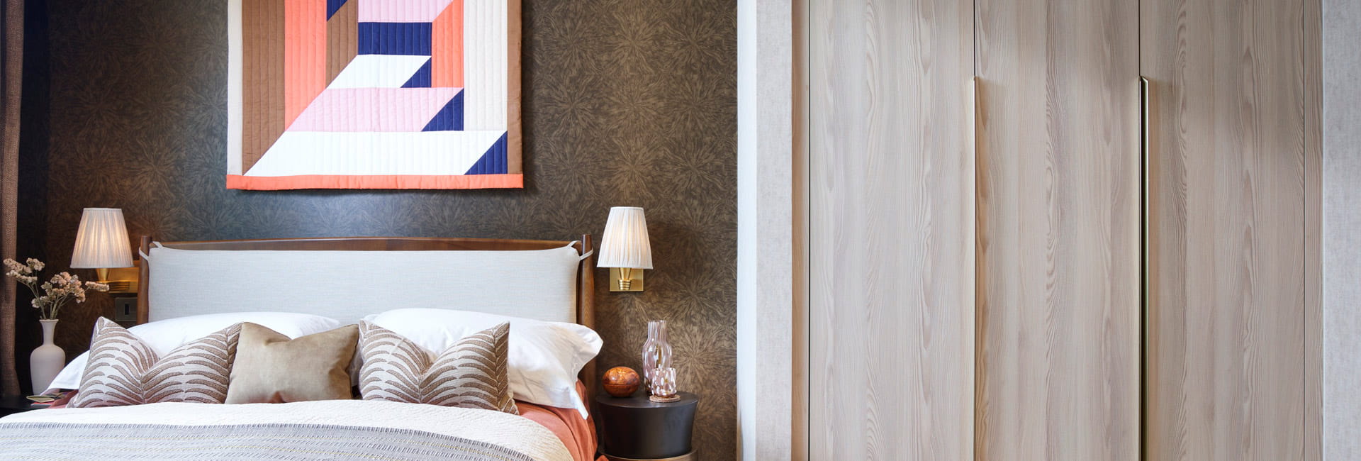 Double bed with contemporary design, bedside tables and wardrobe adjacent
