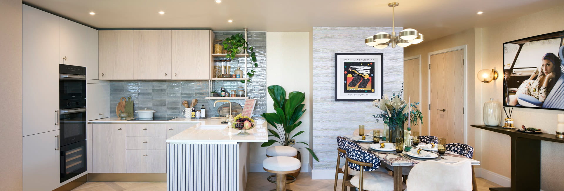 Kitchenette with breakfast island and dining table behind