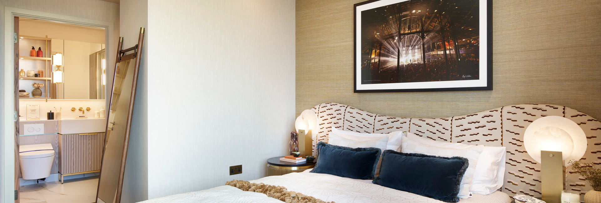 Double bed with contemporary design, bedside tables and wall hanging