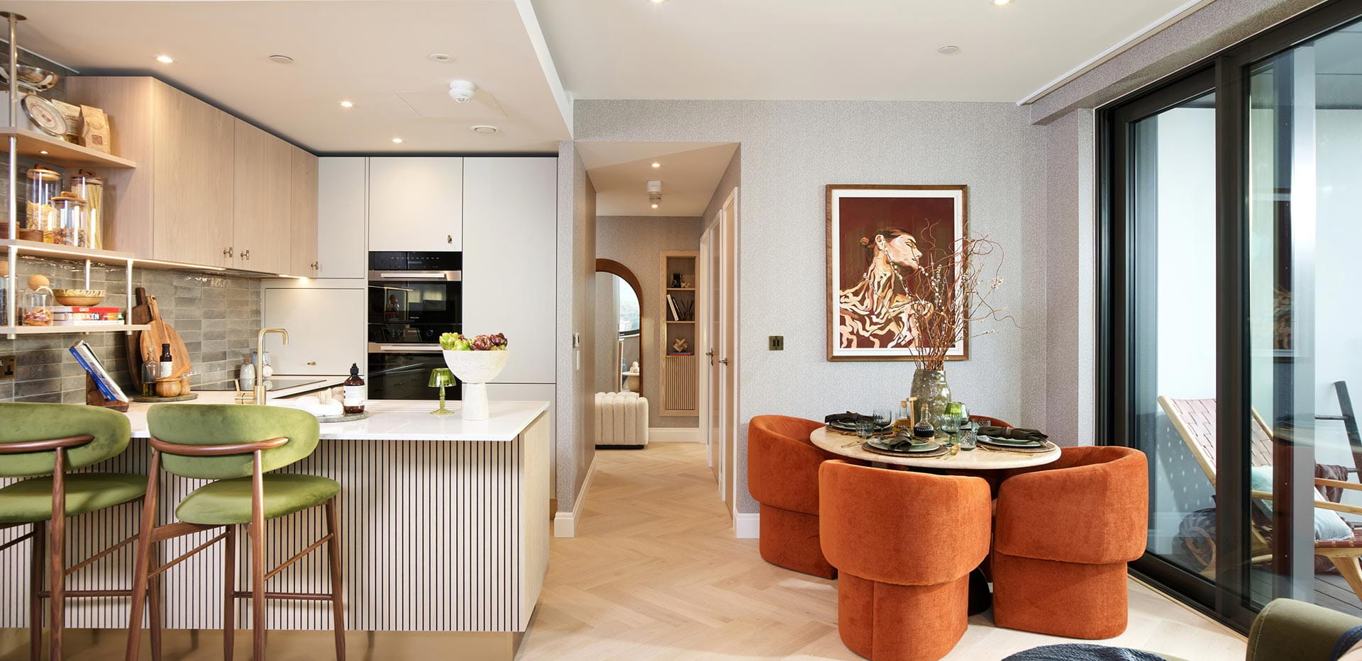 An image of the kitchen-dining area from a One Bedroom Showhome at The Regent