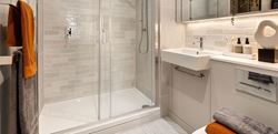 Two bedroom show apartment bathroom with a light design